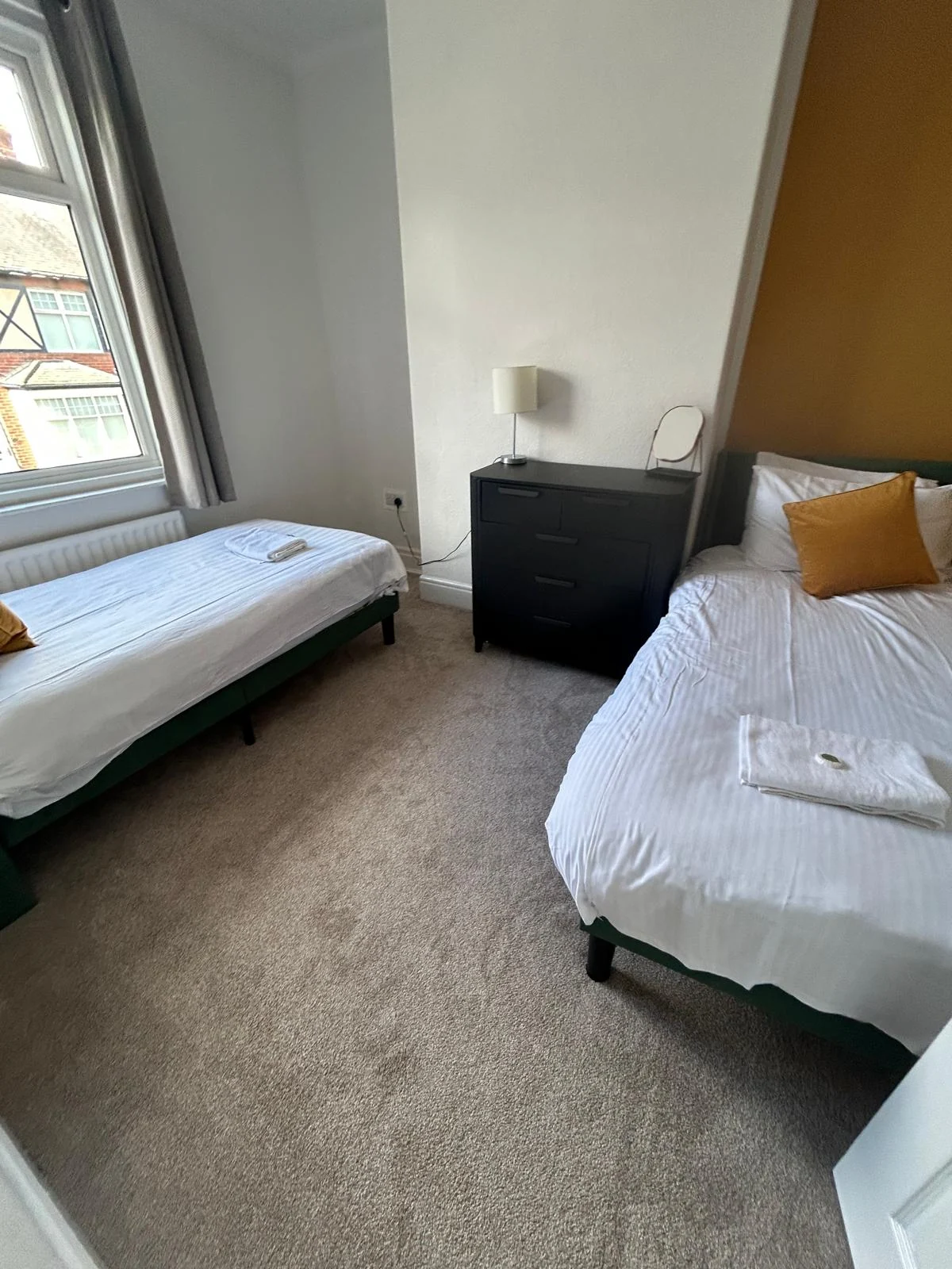 Cosy Quarters twin bedroom prepared with fresh bedding and towels