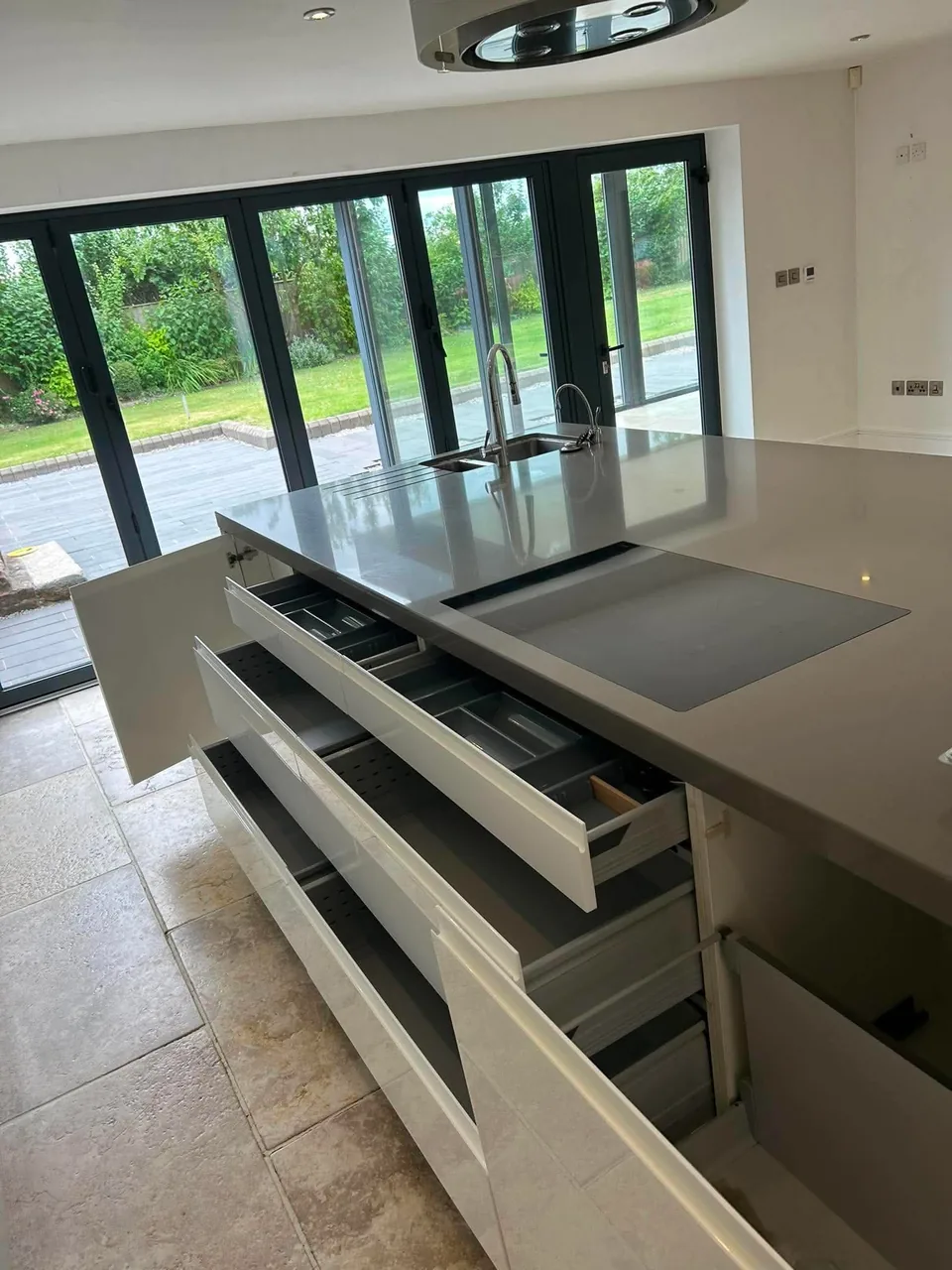 Detailed domestic kitchen cleaning across a large island and integrated storage