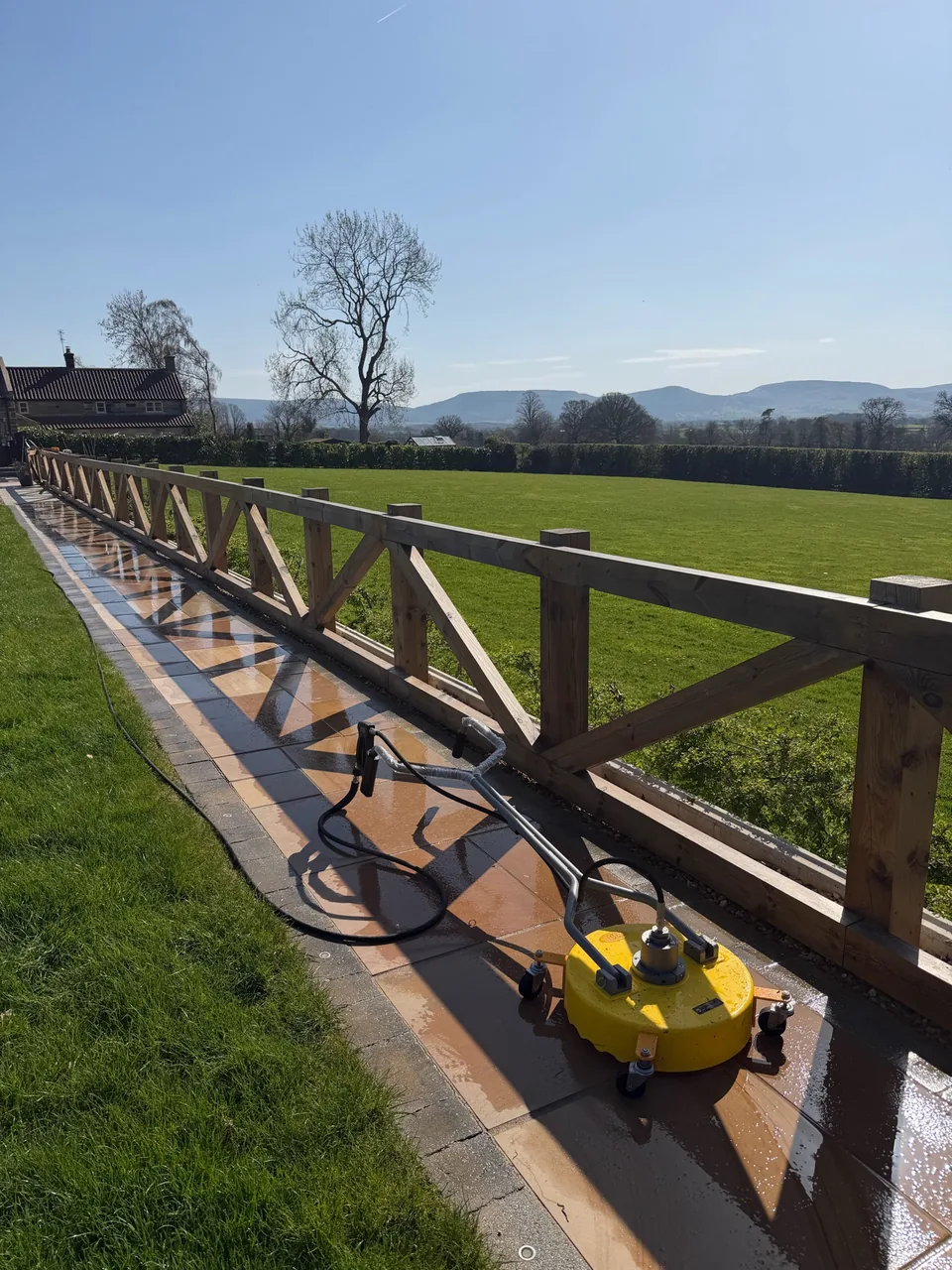 Domestic garden pathway being cleaned with pressure-washing equipment