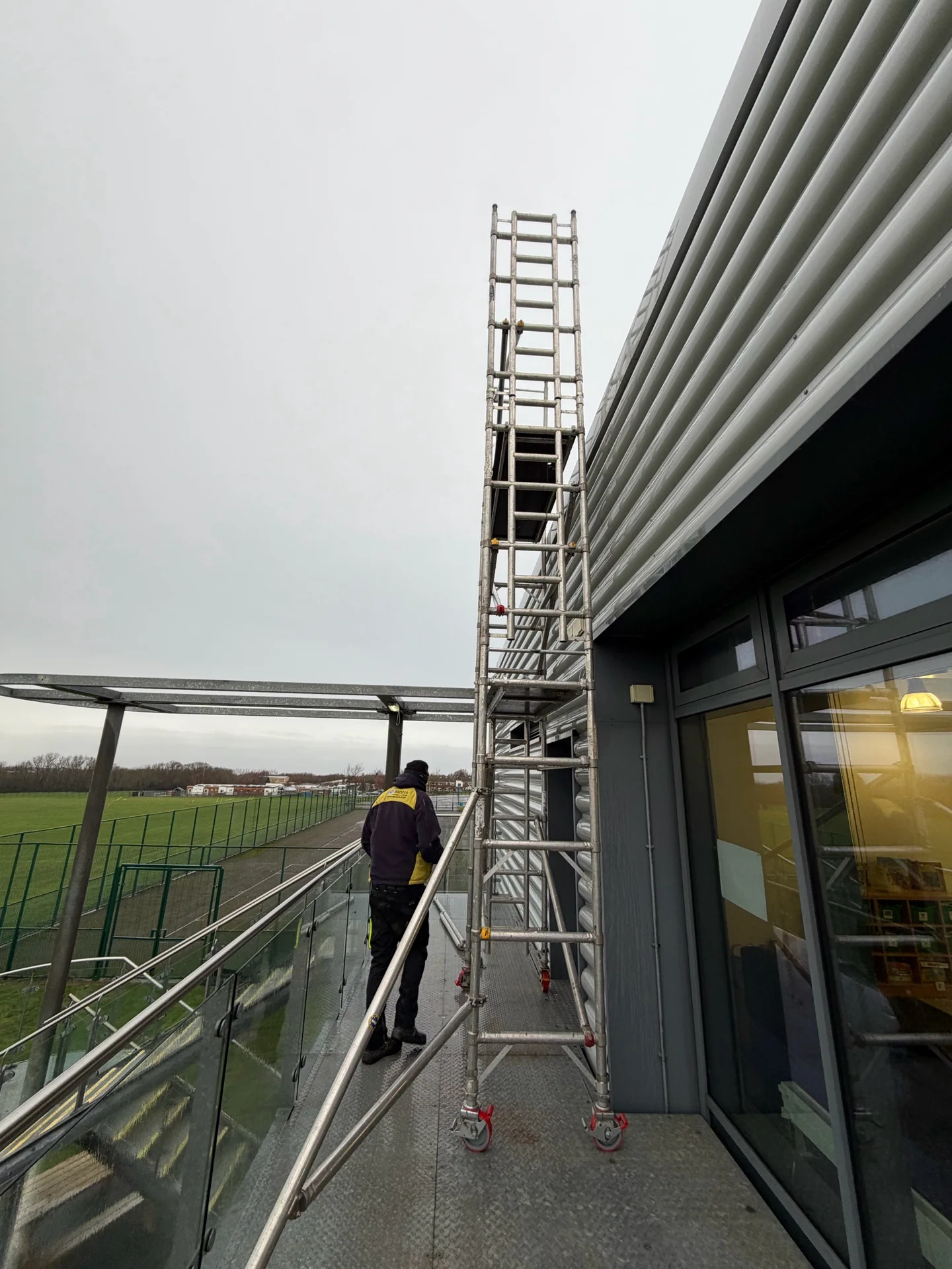 Access equipment positioned beside a school roof-and-gully cleaning project