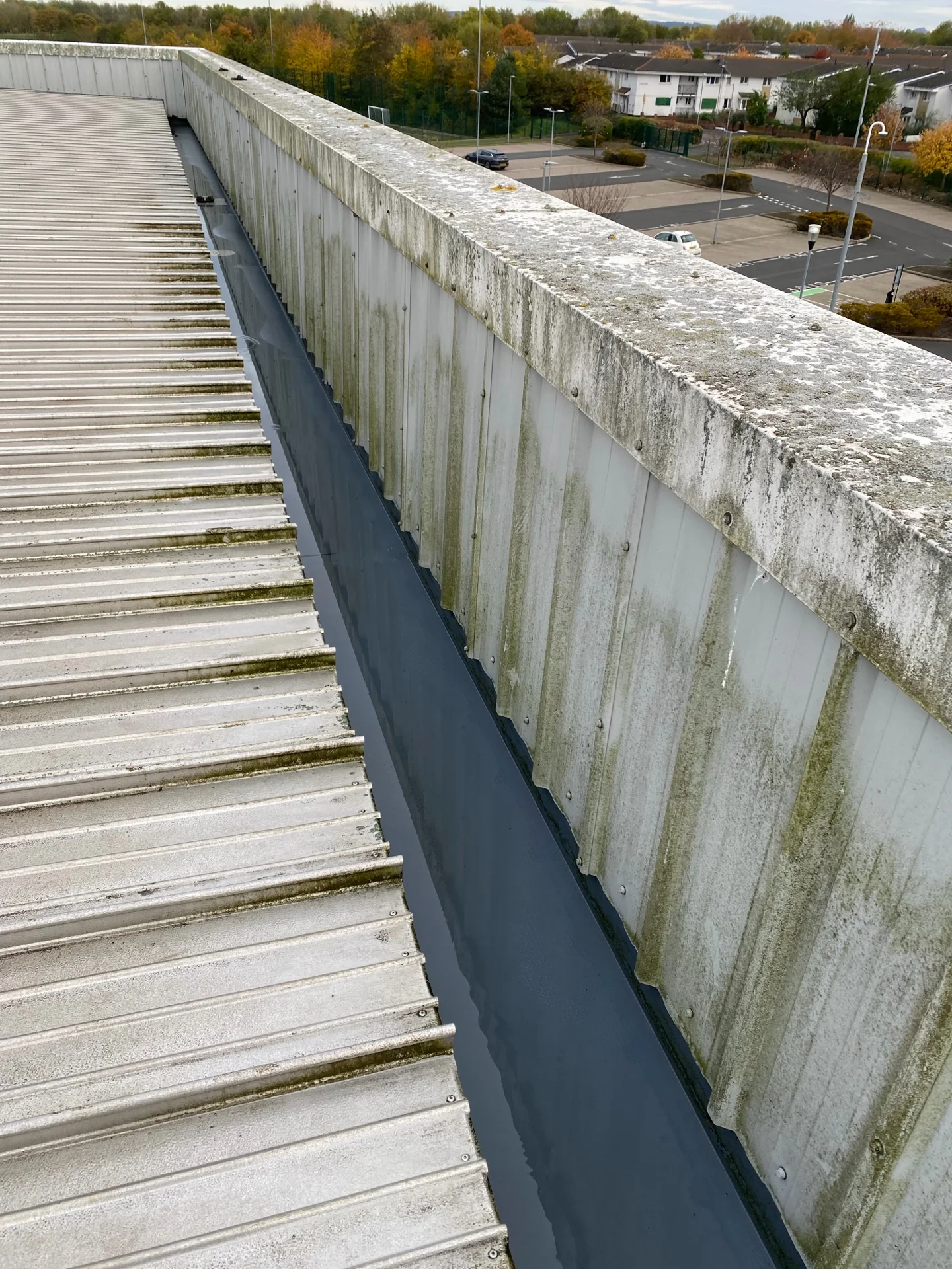 School roof-edge and gully view during the cleaning programme